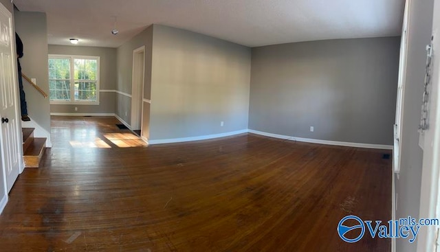 unfurnished room with dark hardwood / wood-style floors