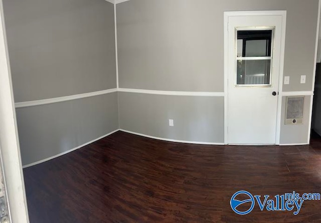 unfurnished room featuring dark hardwood / wood-style flooring