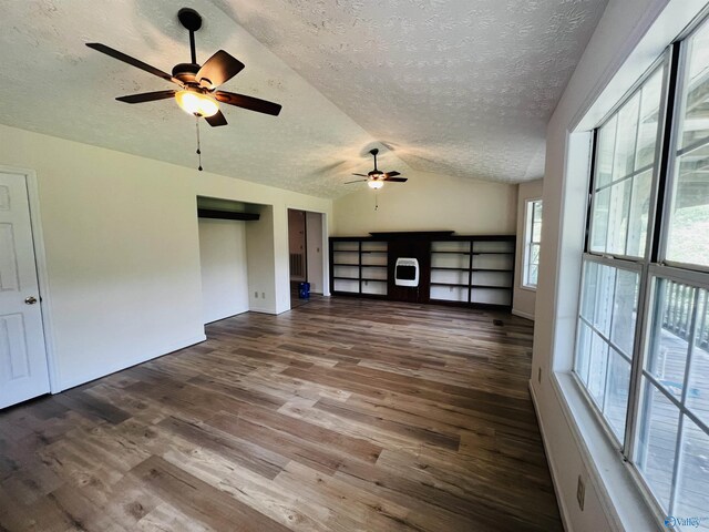 781 Lloyd Rd, Wellington, AL 36279 - unfurnished living room featuring a ceiling fan, dark wood-style flooring, a textured ceiling, and lofted ceiling