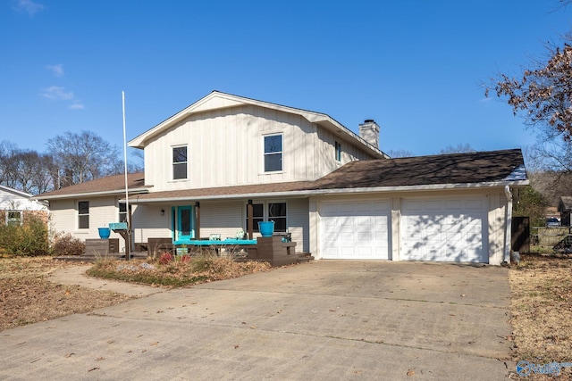 view of front facade with a garage, a chimney, a porch, and concrete driveway