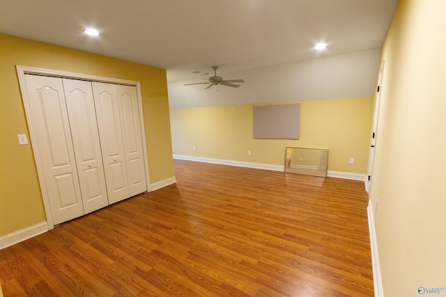 interior space with ceiling fan, lofted ceiling, a closet, and light wood-type flooring