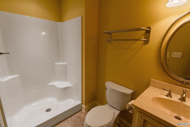 bathroom with vanity, a shower, and toilet