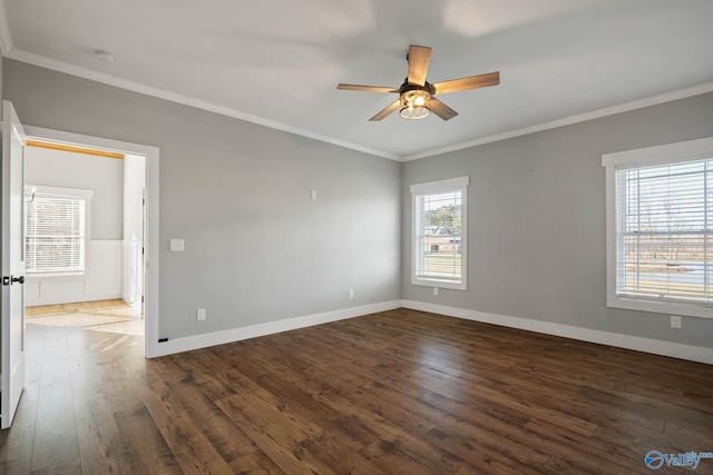 spare room featuring baseboards, ornamental molding, ceiling fan, and wood finished floors