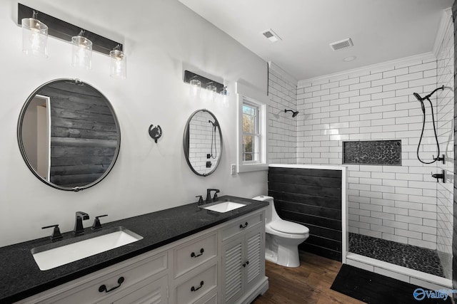 bathroom with walk in shower, a sink, and visible vents