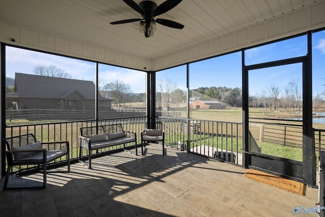 unfurnished sunroom featuring vaulted ceiling and ceiling fan