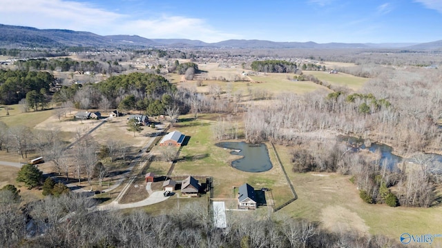 birds eye view of property featuring a water and mountain view and a rural view