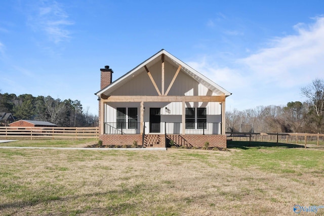 view of front of property featuring a chimney, fence, and a front yard