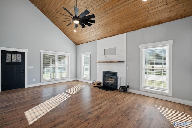 unfurnished living room with baseboards, wooden ceiling, wood-type flooring, a fireplace, and high vaulted ceiling