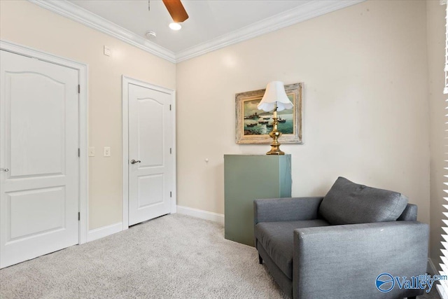 living area with a ceiling fan, carpet floors, ornamental molding, and baseboards