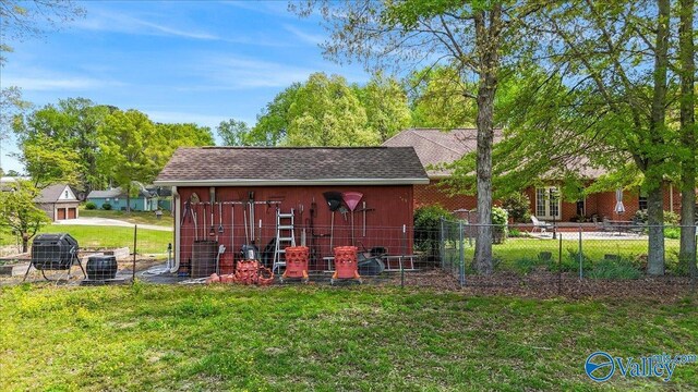 view of outbuilding featuring an outdoor structure and fence