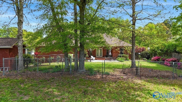 view of yard featuring french doors and fence private yard