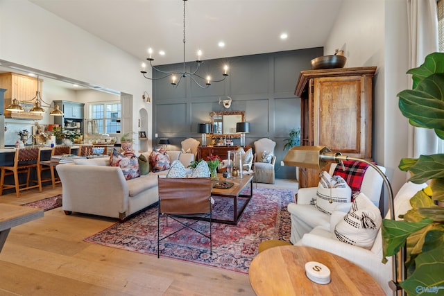 living room featuring light hardwood / wood-style floors and a chandelier