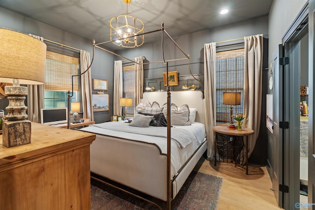 bedroom with wood-type flooring and a chandelier