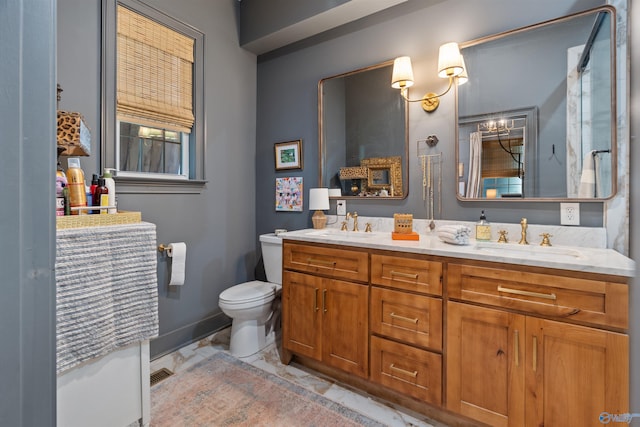 bathroom featuring vanity and toilet