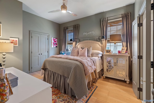 bedroom featuring a closet, light wood-type flooring, and ceiling fan