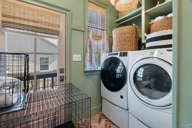 clothes washing area featuring independent washer and dryer