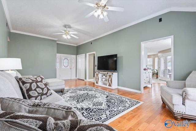 living room featuring hardwood / wood-style flooring, ornamental molding, french doors, and ceiling fan