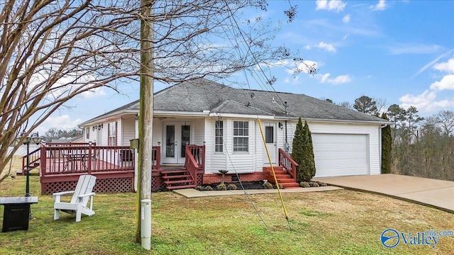 ranch-style house with entry steps, an attached garage, concrete driveway, a front yard, and a shingled roof