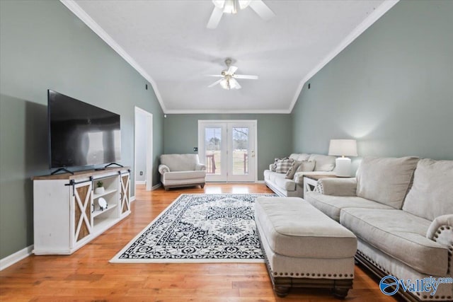 living room with crown molding, vaulted ceiling, ceiling fan, and hardwood / wood-style flooring