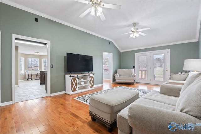 living room featuring baseboards, ornamental molding, a ceiling fan, lofted ceiling, and hardwood / wood-style floors