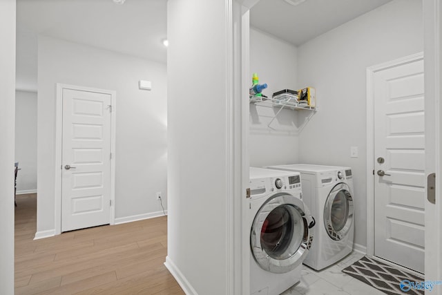 302 Shangrila Way, Meridianville, AL 35759 - washroom with washer and clothes dryer, baseboards, and light wood finished floors