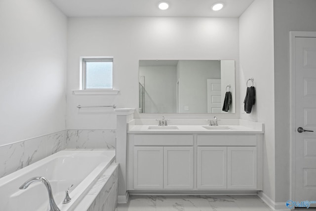 302 Shangrila Way, Meridianville, AL 35759 - bathroom featuring marble look tiles, double vanity, a bath, and baseboards