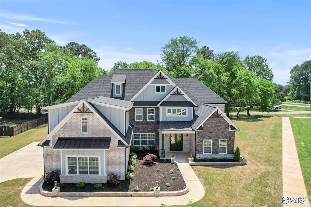 20630 Calcutta St, Athens, AL 35611 - craftsman-style house featuring board and batten siding, metal roof, a front yard, and a standing seam roof