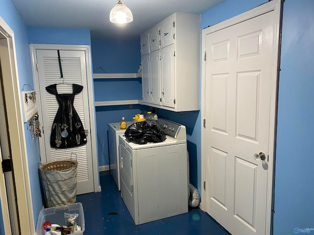 washroom featuring washer and clothes dryer and cabinets