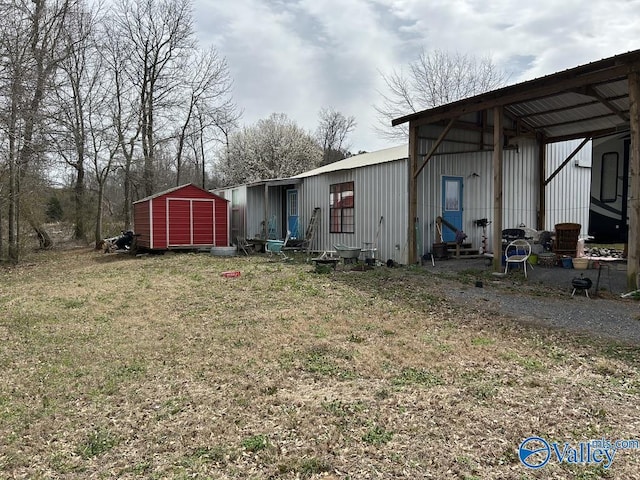 exterior space with entry steps, a shed, and an outbuilding
