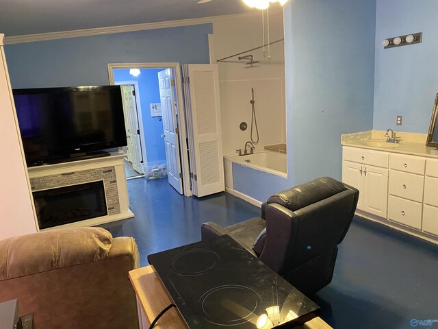 living room featuring sink, a stone fireplace, and crown molding