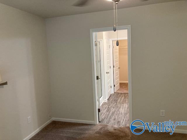 carpeted spare room with baseboards