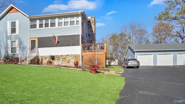 view of front of home with a sunroom and a front yard