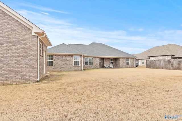 back of property featuring a yard