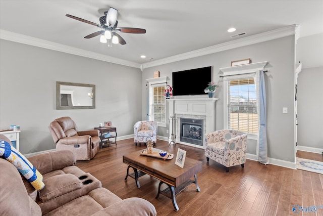 living room featuring dark hardwood / wood-style floors, ceiling fan, and ornamental molding