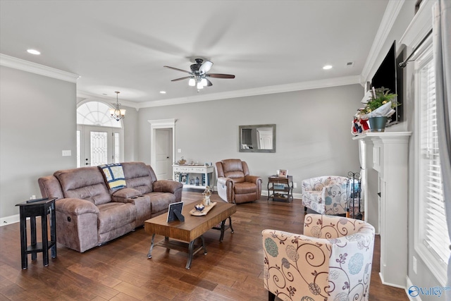 living room with dark hardwood / wood-style flooring, ceiling fan with notable chandelier, and ornamental molding