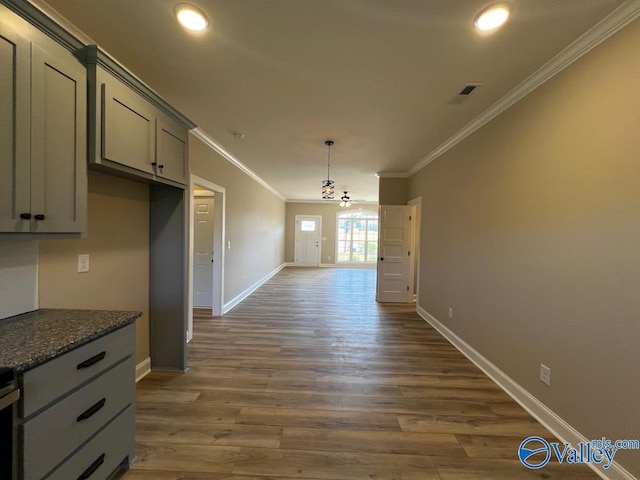 100 James Bowie Dr, Athens, AL 35611 - kitchen with crown molding, gray cabinetry, wood finished floors, baseboards, and dark stone counters