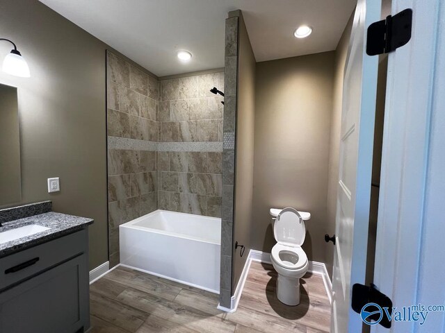 100 James Bowie Dr, Athens, AL 35611 - bathroom with wood finished floors, vanity, baseboards, toilet, and shower / bathtub combination