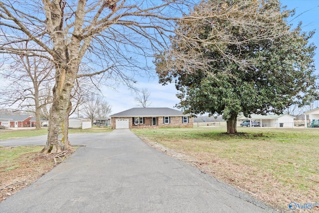 view of front of house with a garage and a front lawn