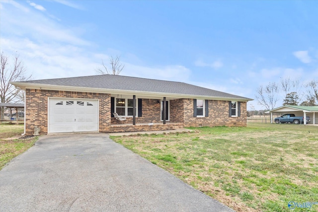 ranch-style home featuring a carport, a garage, and a front lawn