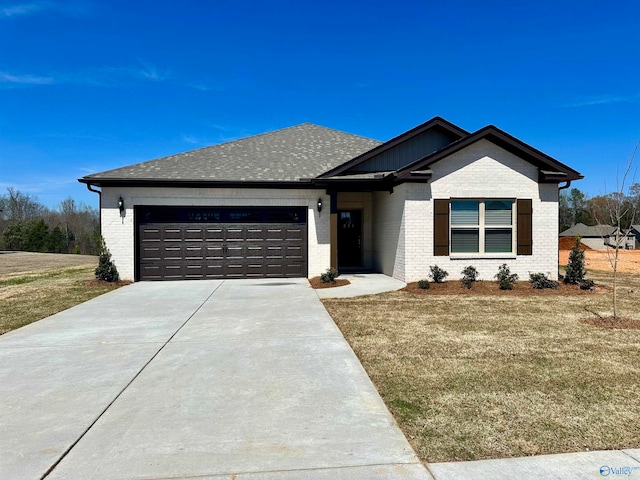 view of front of property with a front yard and a garage