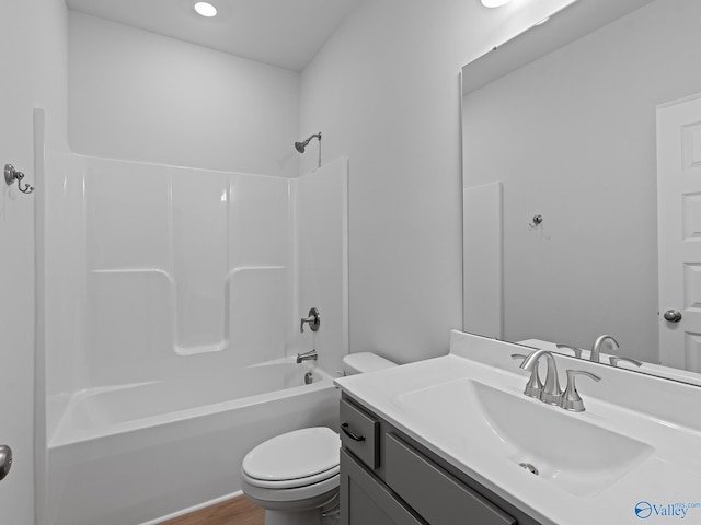 full bathroom with washtub / shower combination, vanity, toilet, and wood-type flooring