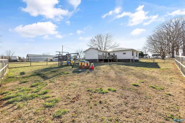 view of yard with a deck and fence