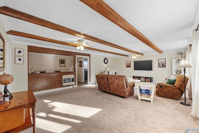carpeted living area featuring crown molding, beamed ceiling, a ceiling fan, and heating unit