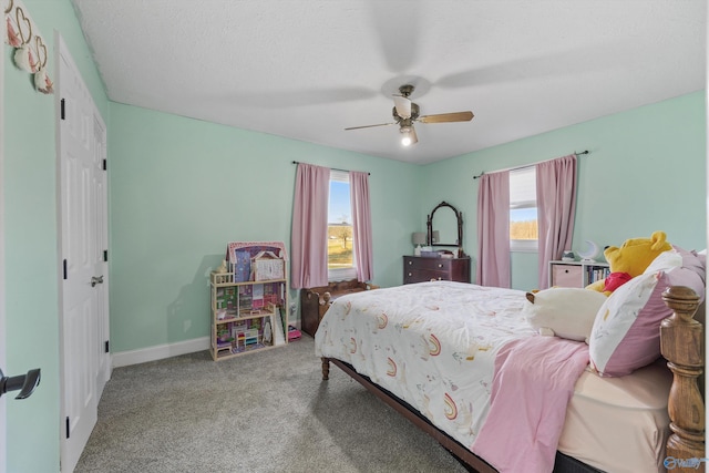 bedroom with carpet flooring, multiple windows, baseboards, and ceiling fan