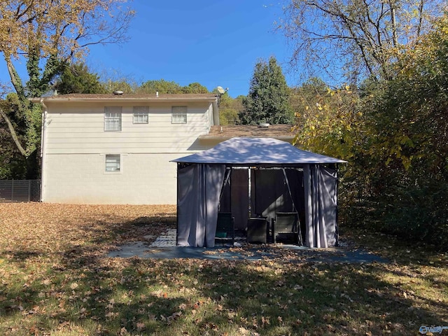 rear view of property with a lawn