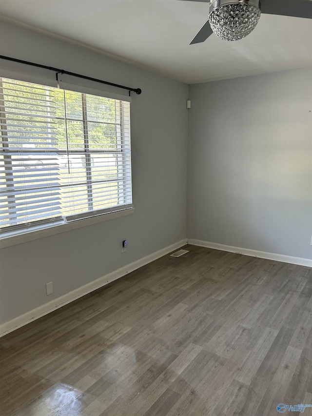 unfurnished room with ceiling fan and wood-type flooring