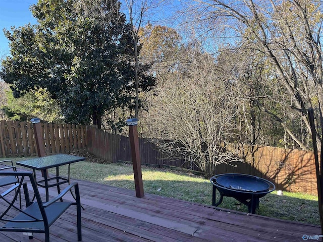 wooden deck with a fire pit