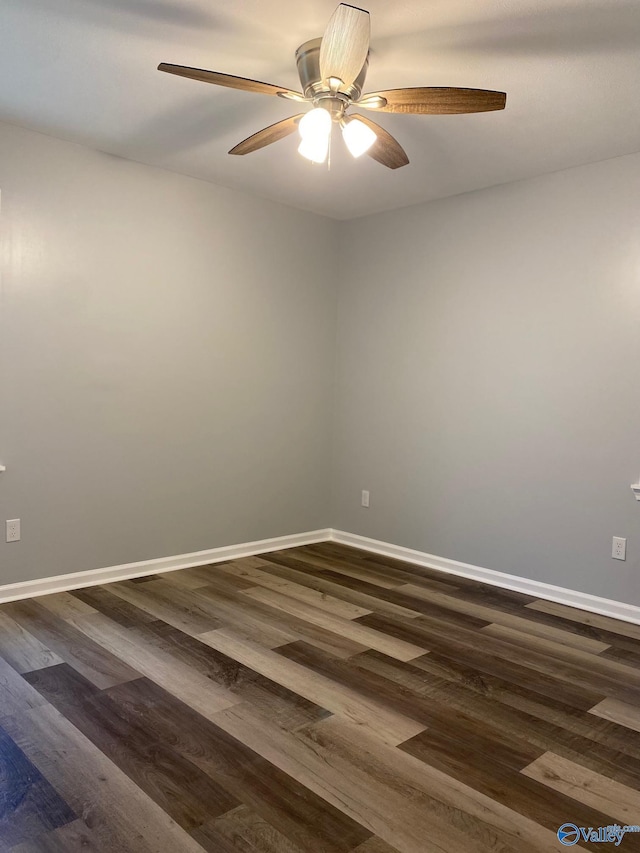 empty room featuring dark wood-type flooring and ceiling fan