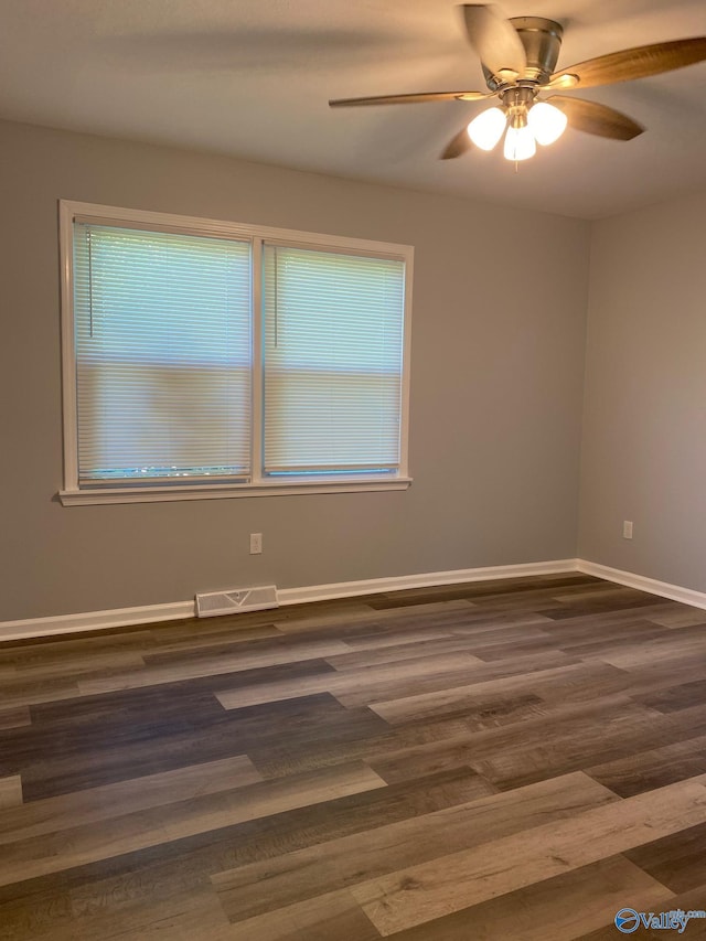 spare room featuring ceiling fan and dark hardwood / wood-style floors