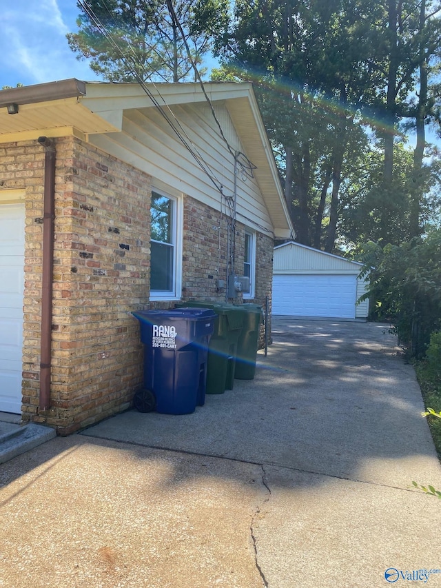 view of side of property with a garage and an outbuilding